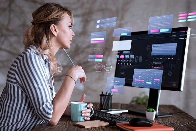 Frau arbeitet an einem Computer mit Datenvisualisierung; Konzept der Softwareentwicklung.