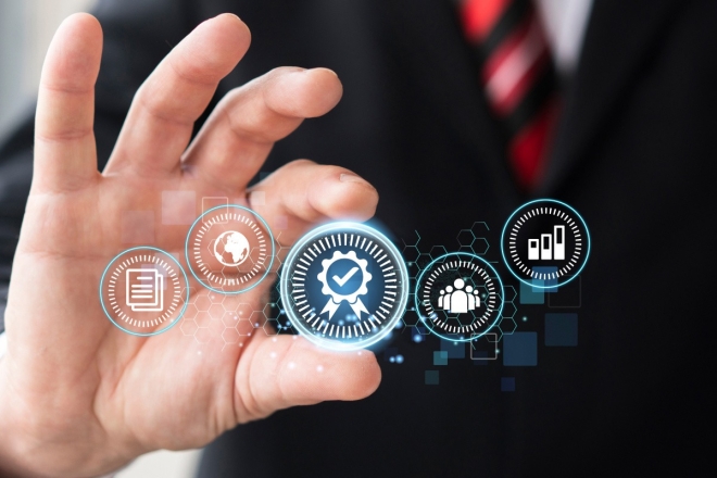 Quality assurance: Hand holding glowing certification badge icon for business standards.