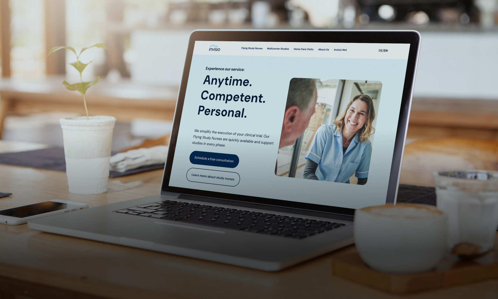 Laptop mit Gesundheitswebsite auf einem Holztisch mit Kaffee und Pflanze. Telemedizinische Dienste.