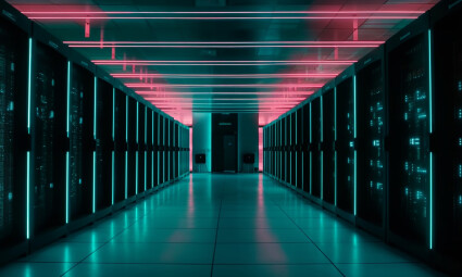 Data center hallway with server racks illuminated by neon pink and teal lights.